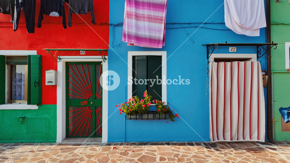 Revealing a street with colorful and traditional houses in the island of Burano, Venice, Italy. Venice is an archipelago of 126 islands separated by canals linked by 472 bridges