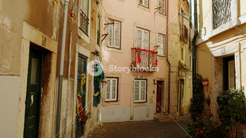 Walking along the picturesque streets of Alfama, the oldest district of Lisbon, Portugal, on the slope of the Sao Jorge Castle
