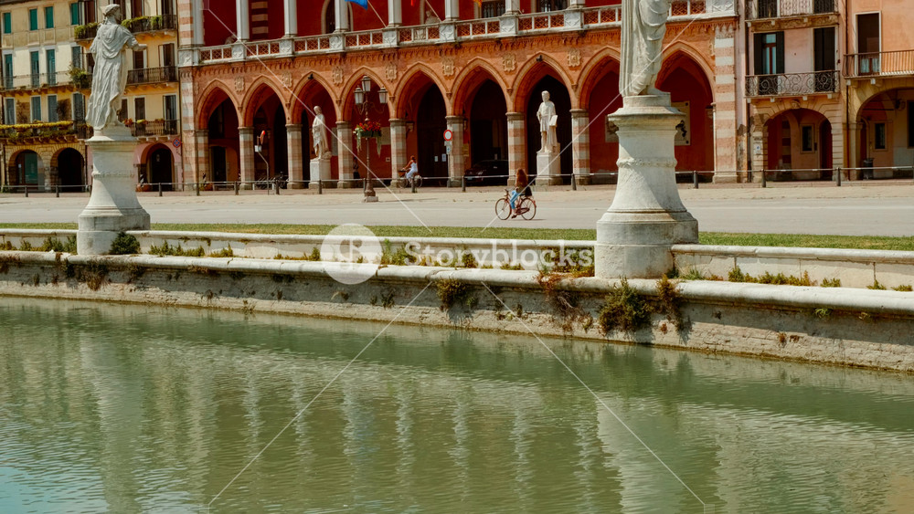 PADOVA, Italy, 15 JULY 2024 - An expansive green island ringed by reflective canals and historic sculptures in the heart of the plaza, Prato della Valle Square, Padova, Padua, Veneto, Italy