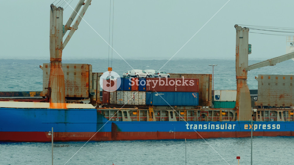 AZORES, Portugal, 17 May 2022 - Telephoto shot of a large freight ship preparing to unload cargo in the Port of Ponta Delgada, The Azores, Portugal