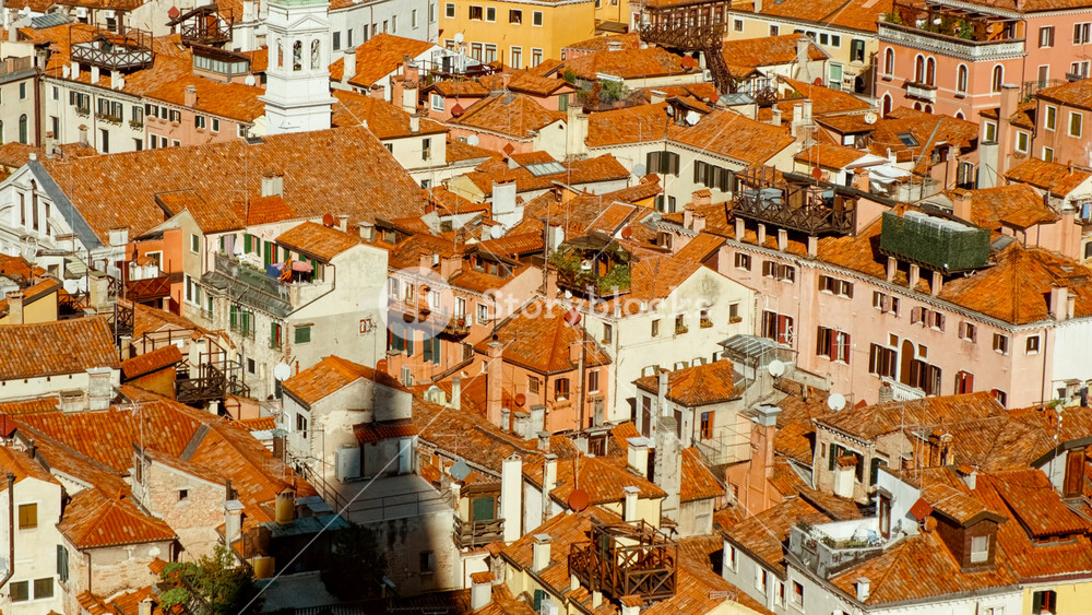 Aerial view of Venice, Veneto, Italy, revealing the lagoon city with canals, islands, church domes and red tiled roofs spreading toward the horizon