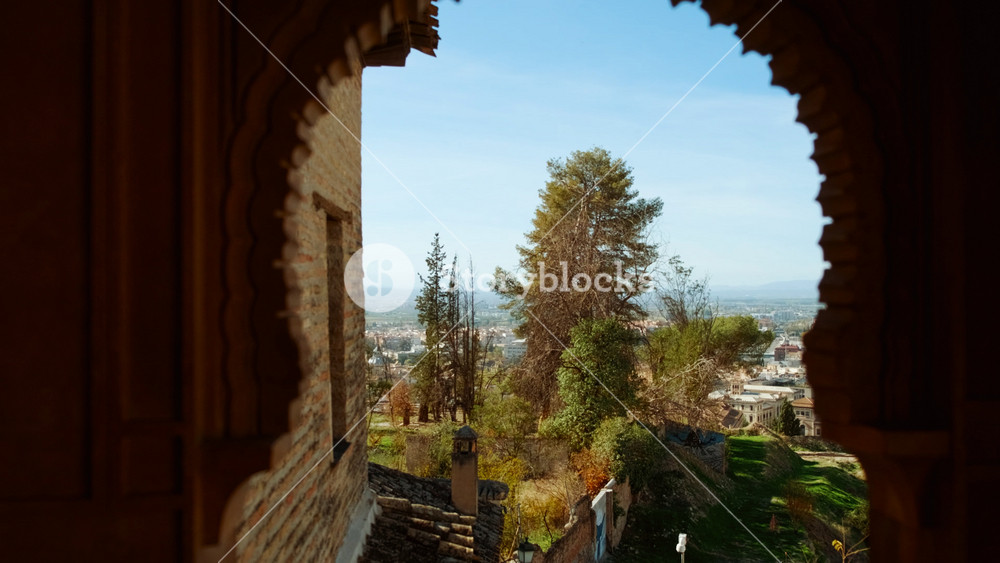 The Albaicin, Albayzin, quarter of Granada, Andalucia, Spain, is bathed in sunset hues, casting a glow over the maze of houses and cypress trees