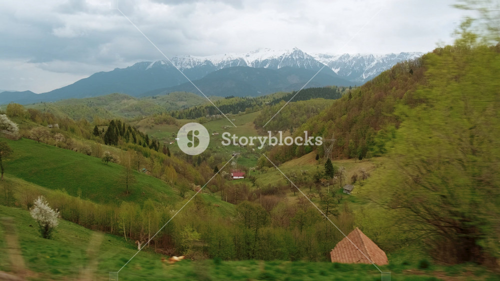 Driving through wonderful pastoral scene in the heart of the Transylvanian mountains, with lush vegetation and quaint houses