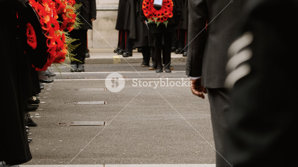 LONDON, United Kingdom, circa 2021 - A dignitary holding a wreath of poppies is seen in Whitehall, London, England, UK during the traditional Remembrance Sunday