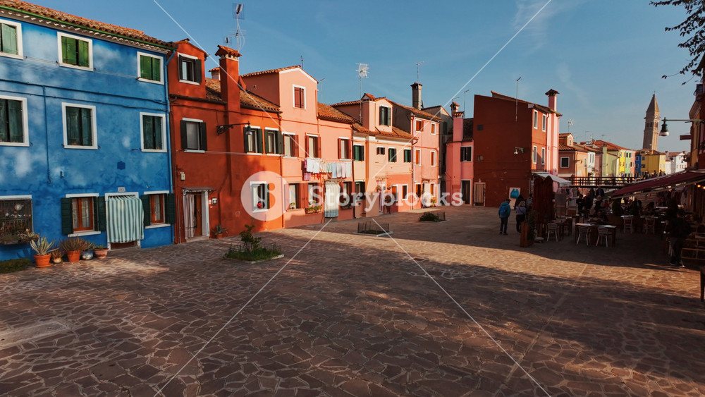 VENICE, Italy, 9 NOVEMBER 2024 - Revealing a group of colorful and traditional houses in the island of Burano, Venice, Italy beautifully reflected in the water