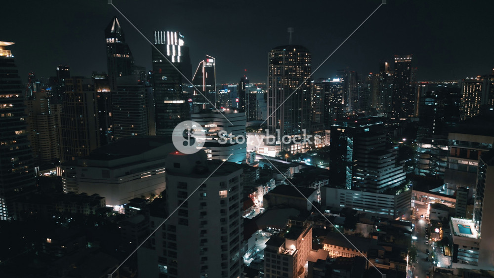 Night aerial shot of downtown Bangkok. Night business city skyline view. Aerial shot urban landscape after dark with urban ambiance with