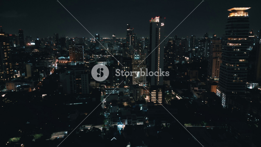 Aerial view of the urban landscape after dark, with urban ambiance, alive with vibrant lights. City at night downtown district, illuminated
