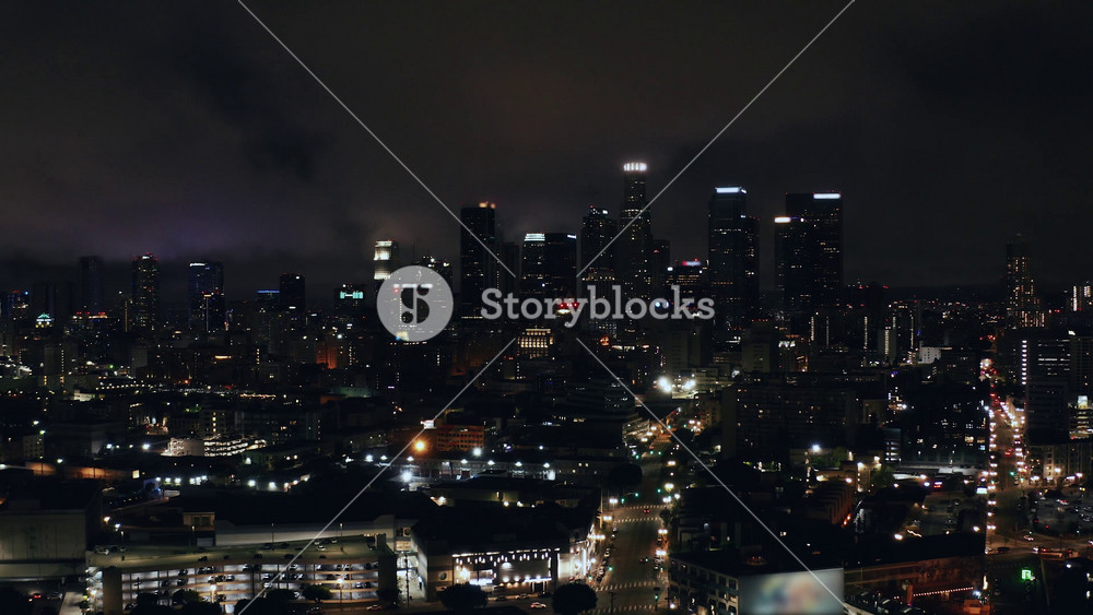 Discover the vibrant nightlife of Los Angeles through breathtaking aerial views showcasing city lights and iconic skyscrapers under a starry sky