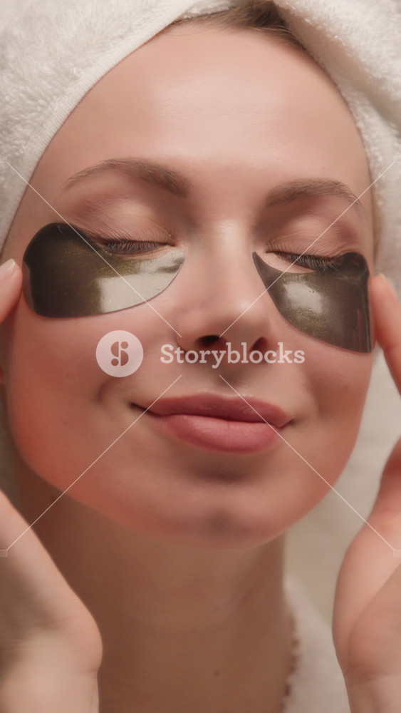 Skincare Caucasian woman in bath towel eye-patches skin refreshment blowing kiss beautiful female young model hydrogel cooling gel eye patch