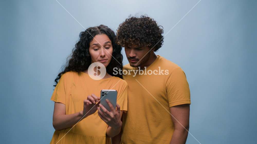 Multiracial with mobile phone choosing shopping online woman showing offer to man booking order happy find choice thumbs up goals courting