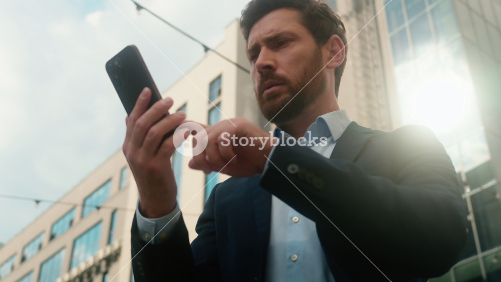 Middle-aged Caucasian business man confused with mobile phone lost signal Wi-Fi connection problem in city frustrated businessman male