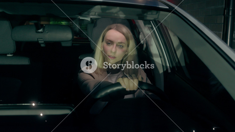 Careful Caucasian business woman female girl businesswoman car buyer auto driver riding inside automobile looking around driving electric