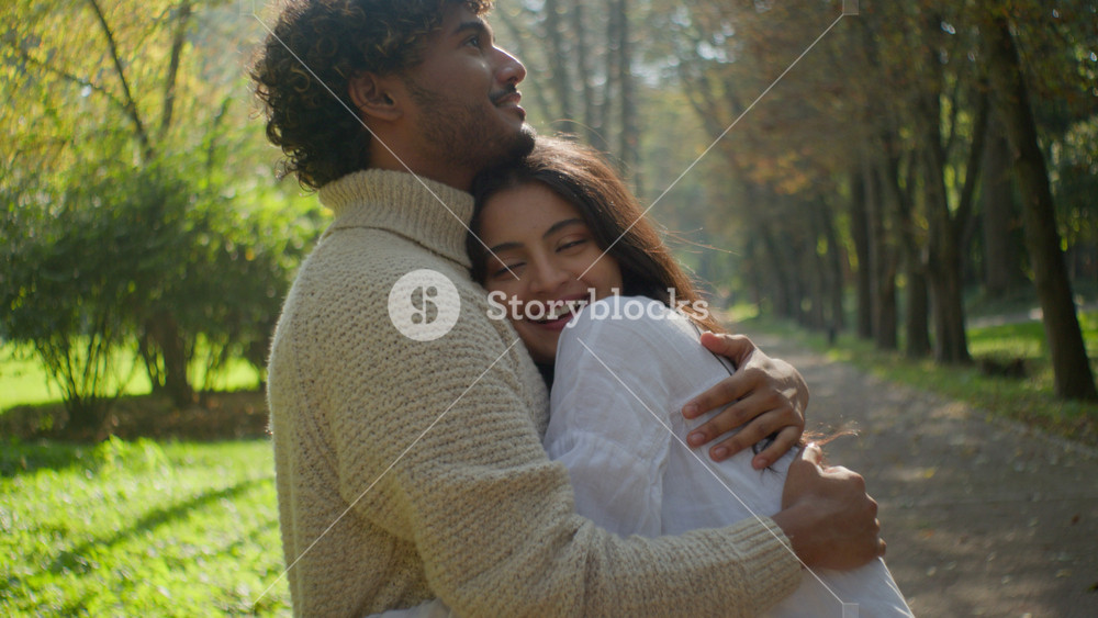 Happy multiethnic loving romantic couple family Arabian Indian man Hispanic woman smile cuddle touching. Male boyfriend female girlfriend