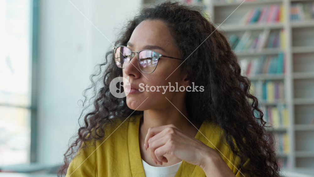 Tired Arabian Latino woman in glasses rubbing eyes in library female girl student exhausted overworked feeling painful eyestrain bad vision
