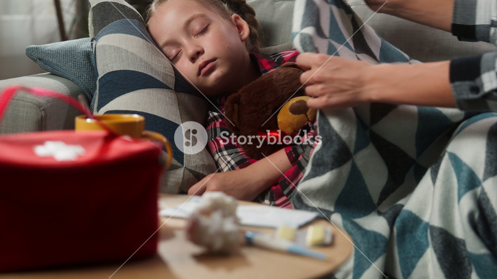 Caucasian family at home ill sick sleeping little girl child kid daughter suffering disease flu caring mother woman female measure fever
