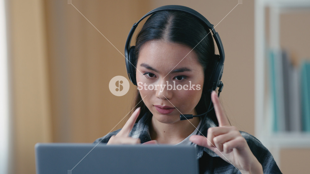 Asian business woman female office worker headset headphones video calling laptop remote conference Korean businesswoman speaking online
