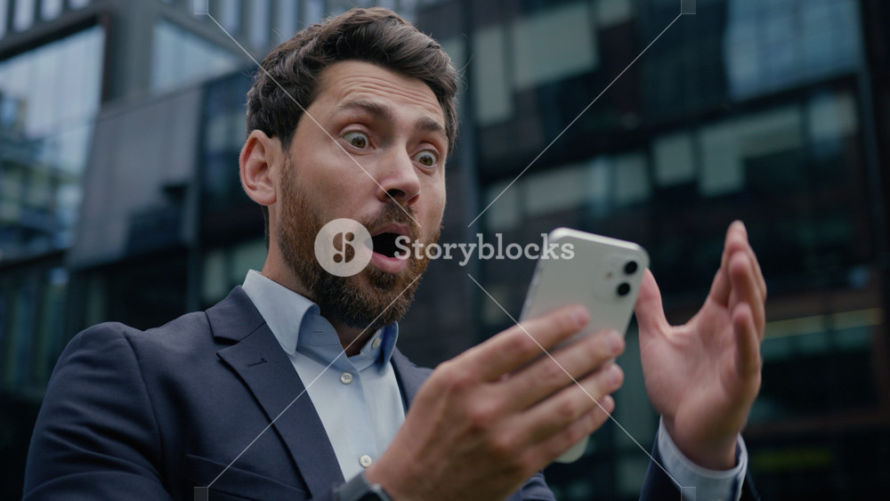 Caucasian man amazed happy businessman look mobile phone message good news win male using smartphone gadget success business shocked