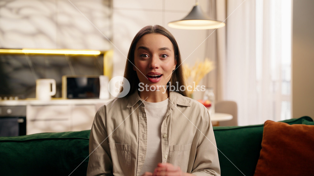 Close up portrait excited happy Caucasian woman European beautiful female smiling rejoice good news surprise in living room looking at