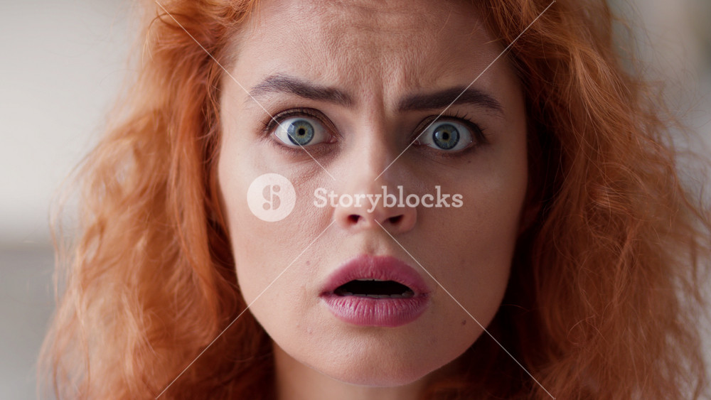 Close up Caucasian woman amazed wonder scared shocked face emotion stunned girl portrait lady looking at camera with big eyes open mouth