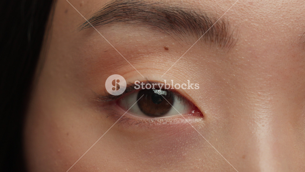 Close up one female open black eye looking at camera Asian woman girl Korean Chinese lady look healthy Japanese ethnic model eyesight vision