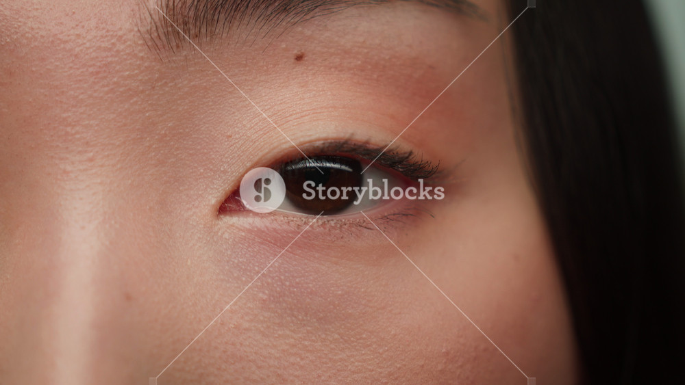 Close up extreme eye dark iris blink looking Asian woman chinese female girl face details healthy vision eyesight eyes laser correction