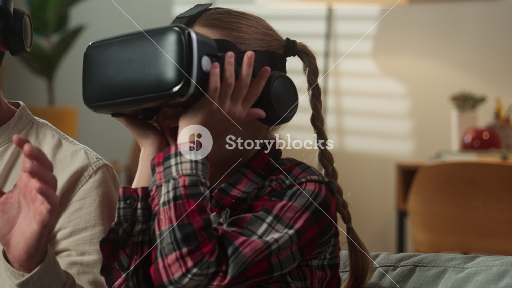 Excited Caucasian family father with emotional scared amazed daughter dad man male with kid girl child at home at couch enjoying online