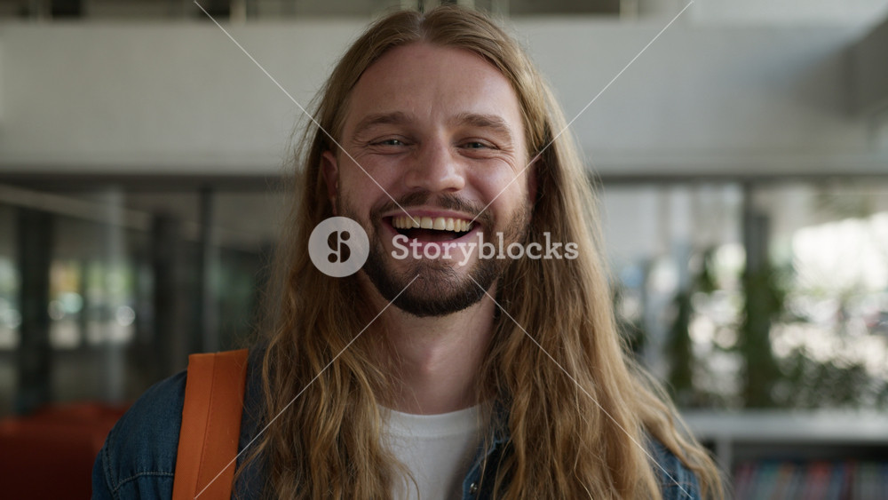 Caucasian student man European male guy winning with mobile phone victory achieve receive good news with smartphone laughing happy rejoice