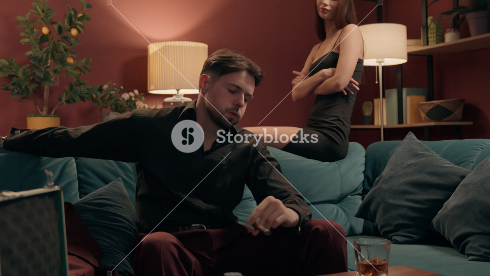 Angry Caucasian man gambler losing poker game smoking cigar with girlfriend home family couple tournament mad male guy boyfriend playing
