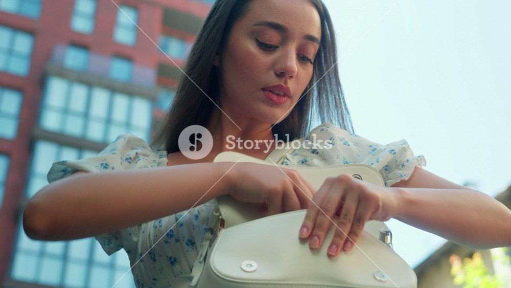 Nervous stressed Caucasian woman female girl client buyer driver nervously looking bag for car keys searching lost key in purse driving