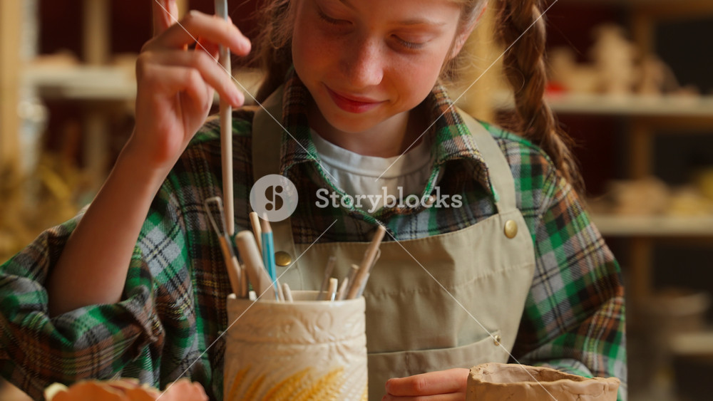 Close up happy creative talented cute little girl teenager Caucasian schoolgirl child kid art school student choosing equipment tool