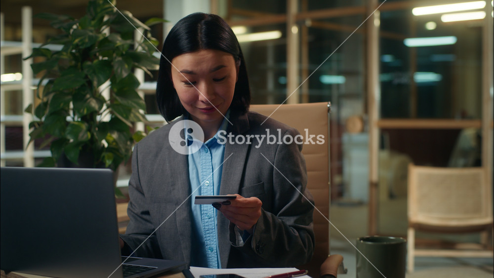 Asian Korean Chinese Japanese woman typing laptop holding banking credit card payment order buying ecommerce girl smiling happy