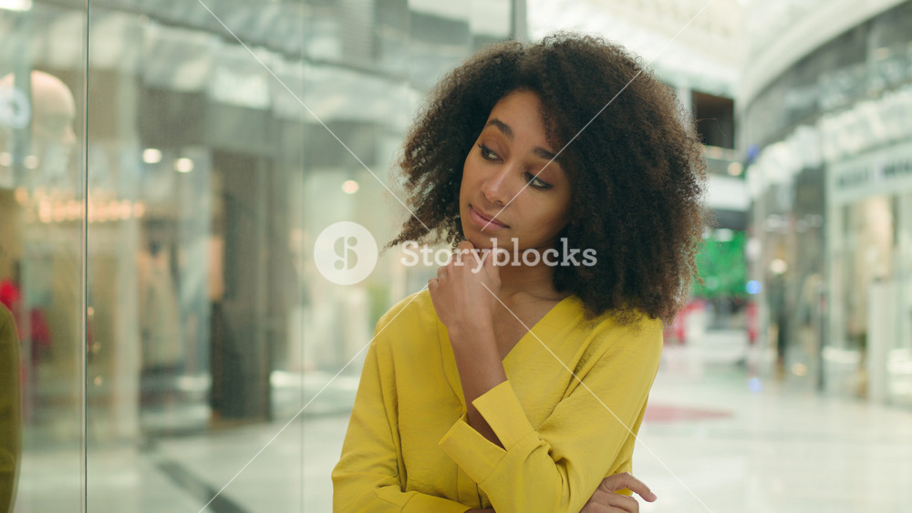 African American woman shopping mall thinking choosing decision pensive female girl shopper buyer customer client consumer shopaholic choice