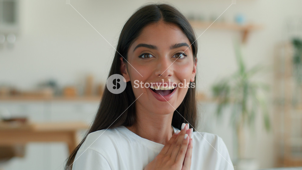 Surprised amazed Indian woman at home looking at camera wow reaction open mouth happy excited good news success achievement Arabian girl