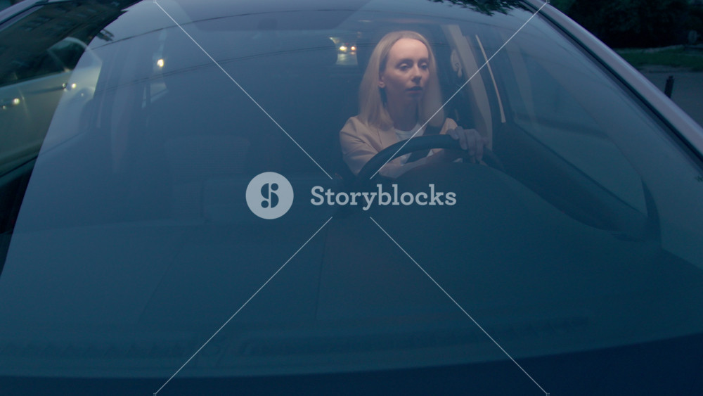 Attentive Caucasian business woman female girl businesswoman rental car owner vehicle driver seat belt sitting inside automobile machine