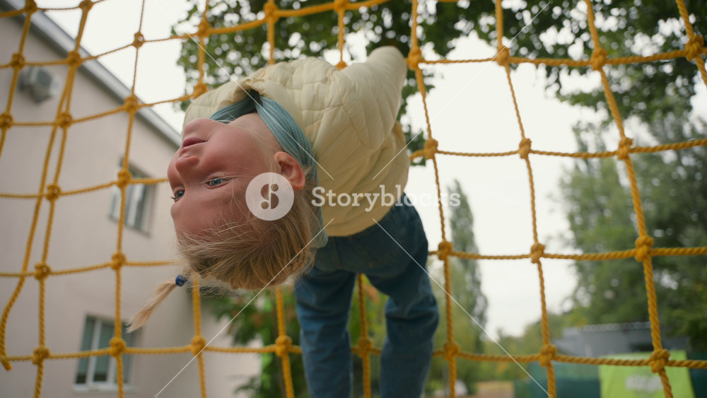European playful girl play sports playground hanging climbing childish funny joy entertainment weekend active adventure lifestyle kid
