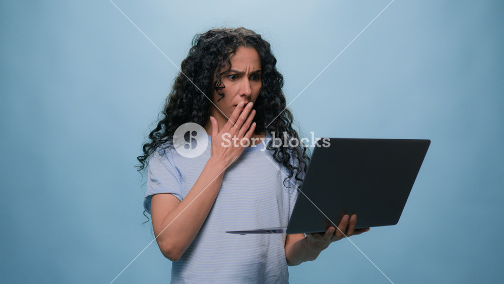 Shocked frustrated Indian student girl Latino upset woman businesswoman with computer failure stressed shock with laptop bad news business