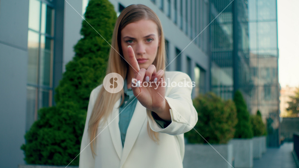 Angry Caucasian business woman showing stop hand gesture outdoors serious female businesswoman girl rejecting offer prohibition warning
