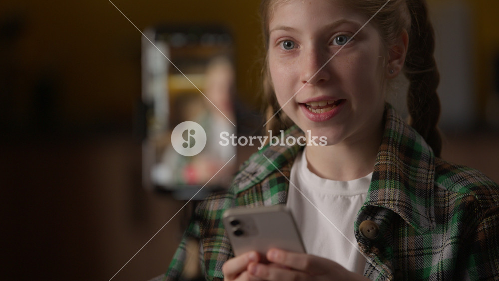 Excited little girl blogger filming blog review mobile phone smartphone camera influencer child Caucasian kid vlogger schoolgirl play online