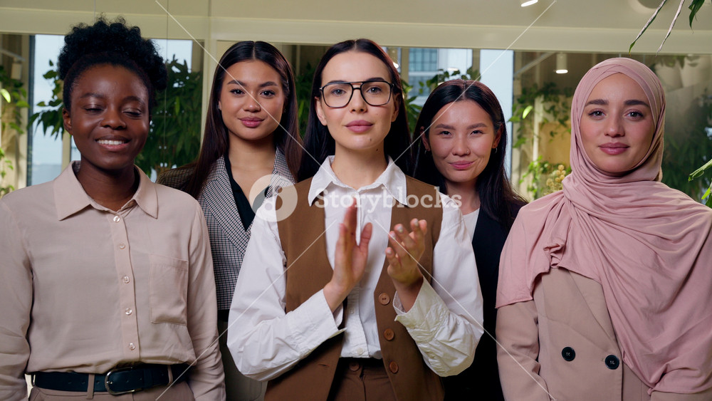 Happy satisfied multiethnic women females diverse group five girls coworkers businesswomen business team nodding head clapping hands