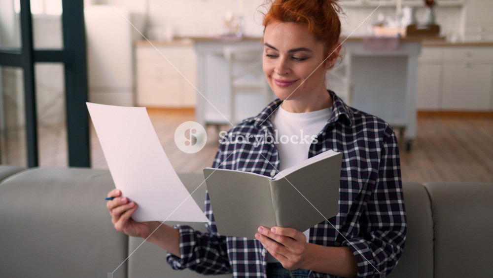 Caucasian woman lady at couch sofa busy at home girl female homeowner writing notes choosing colors palette colorful templates preparing for