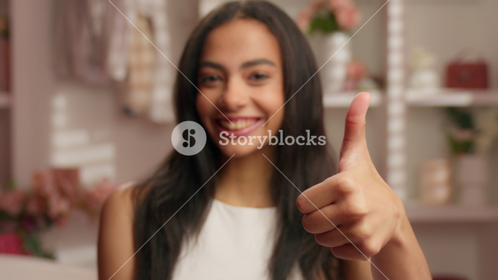 Happy Latina woman Hispanic ethnic girl demonstrate hey you thumb up support agree gesture smiling looking at camera American female smile