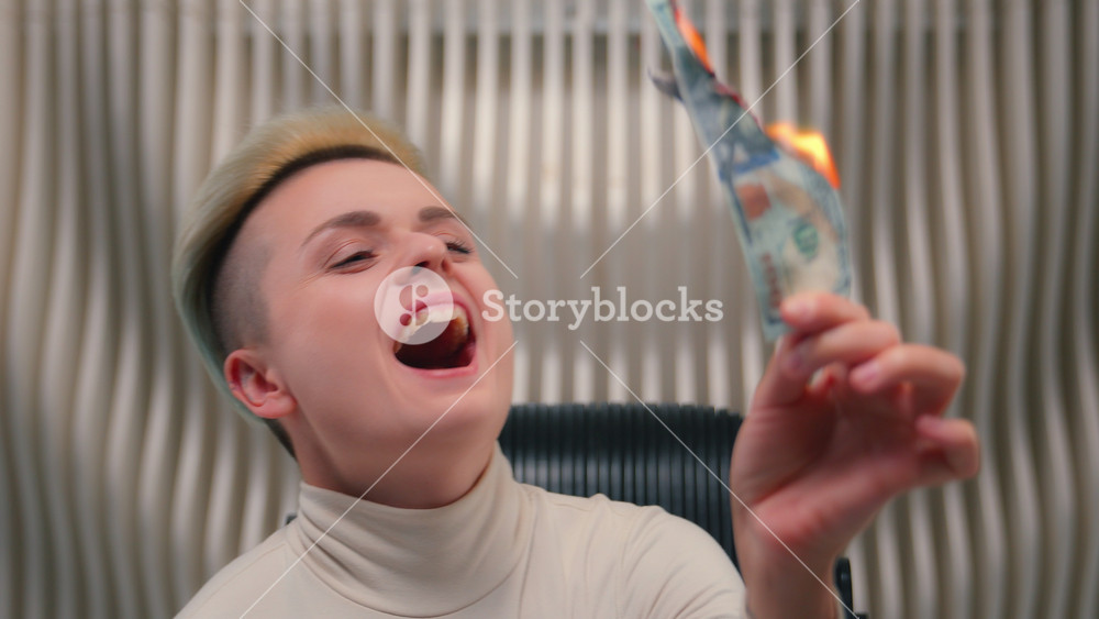 Caucasian female business woman rich wealthy girl crazy insane bizarre businesswoman laugh burn money cash fooling having fun rejoice hold