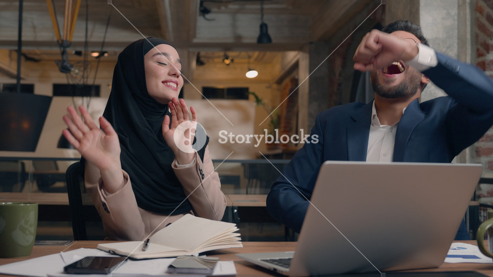 Arabian muslim islamic woman in hijab Indian man business partners corporate colleagues winners male female happy joyful carefree