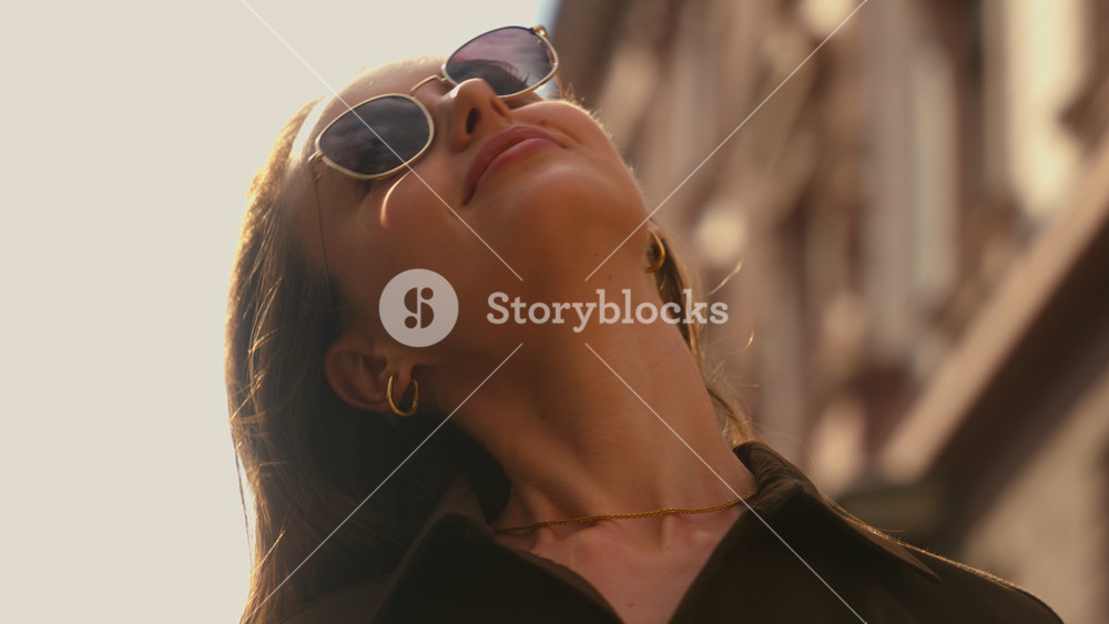 Close up Caucasian stylish happy woman in city put on sunglasses smiling female girl enjoying sunny weather in street sun summer carefree