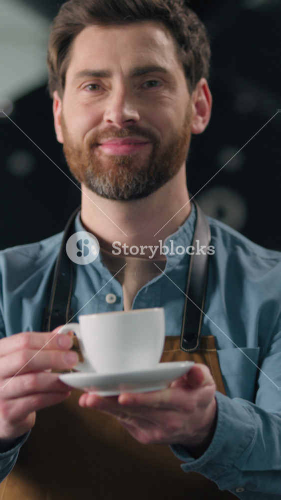 Smiling Caucasian man cafe barista smell fresh aroma caffeine coffee roasting production male small business owner guy in uniform holding