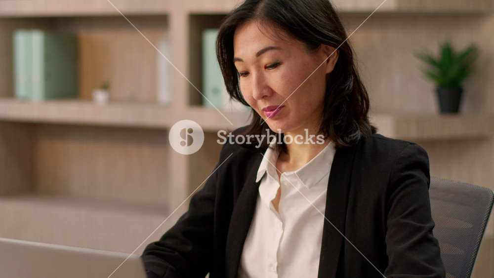 Asian smiling businesswoman adult chinese korean girl female boss sit office table open desktop computer Japanese business woman employer