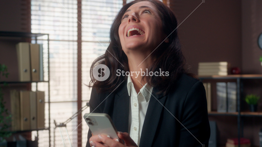 Shocked Caucasian woman holding mobile phone smartphone good news victory winning amazing yes female excited girl businesswoman business