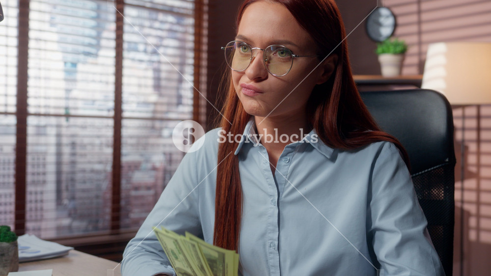 Unhappy Caucasian businesswoman counting cash at office desk business woman female count money financial stress budget failure economy