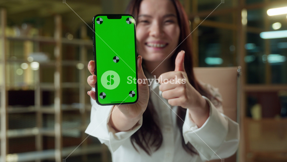 Asian Korean business woman businesswoman using mobile phone showing green screen in office Chinese Japanese girl happy female buyer online