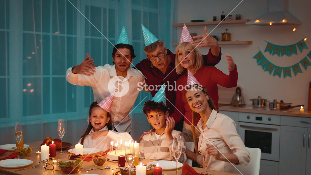 Family members gather around a festive table to celebrate Birthday, wearing party hats and sharing smiles. The atmosphere is filled with